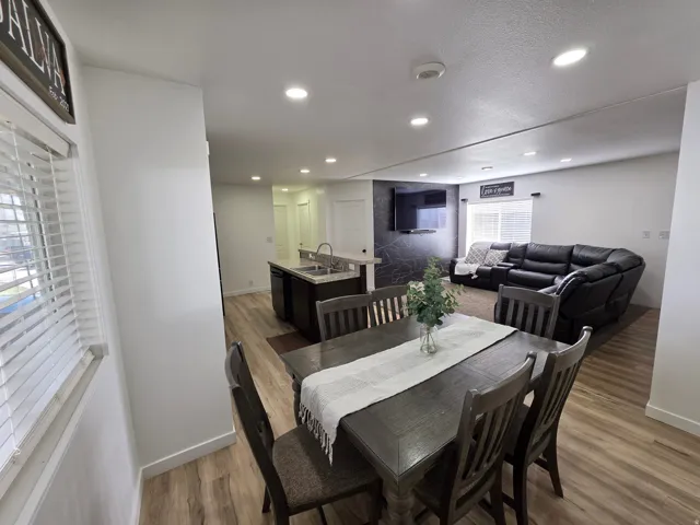 Dining room with light wood-type flooring and recessed lighting