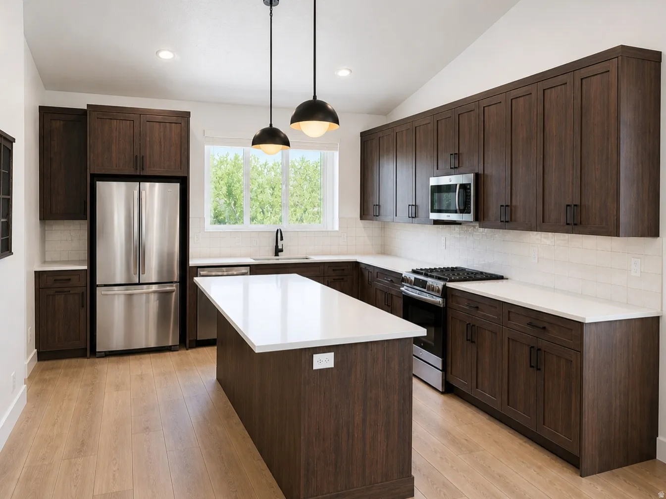 Kitchen featuring dark wood-finish cabinetry, white countertops, and wood-finish flooring