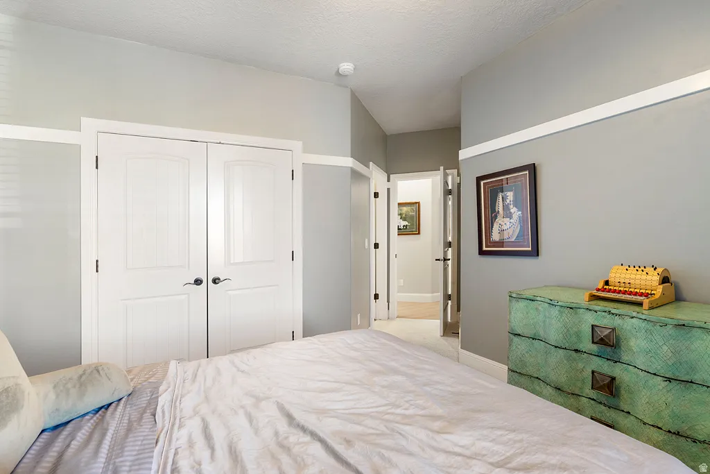 Bedroom featuring a closet and a textured ceiling