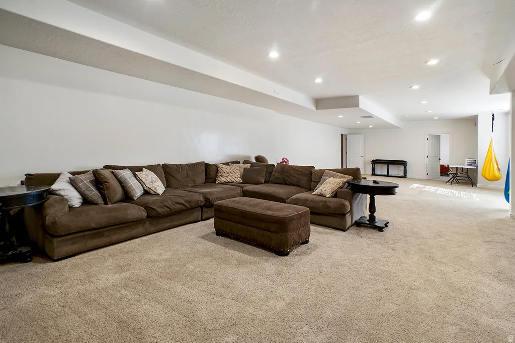 Carpeted living room with recessed lighting