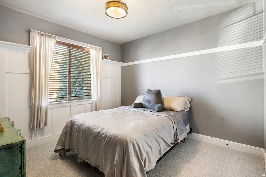 Bedroom with light carpet