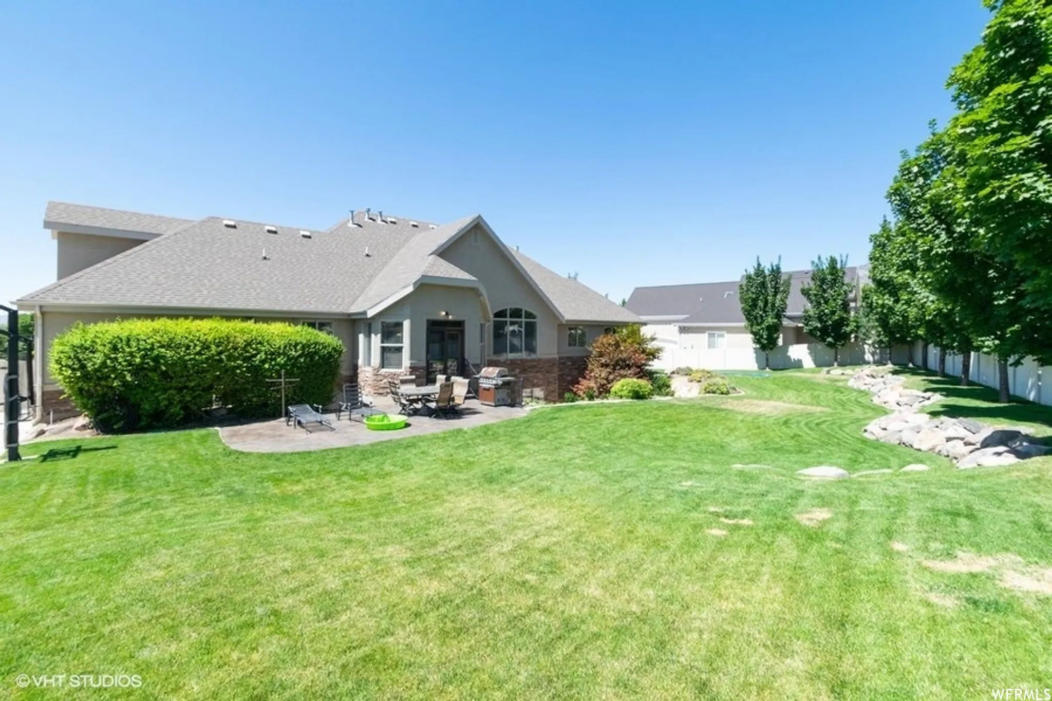 Last Summer - Back of house featuring a patio area, stone siding, and stucco siding