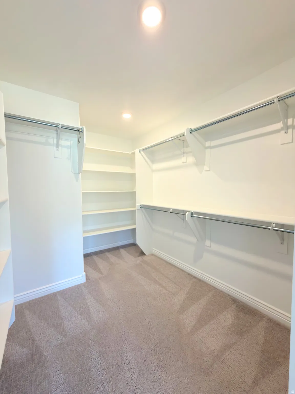 Walk in closet with dark carpet