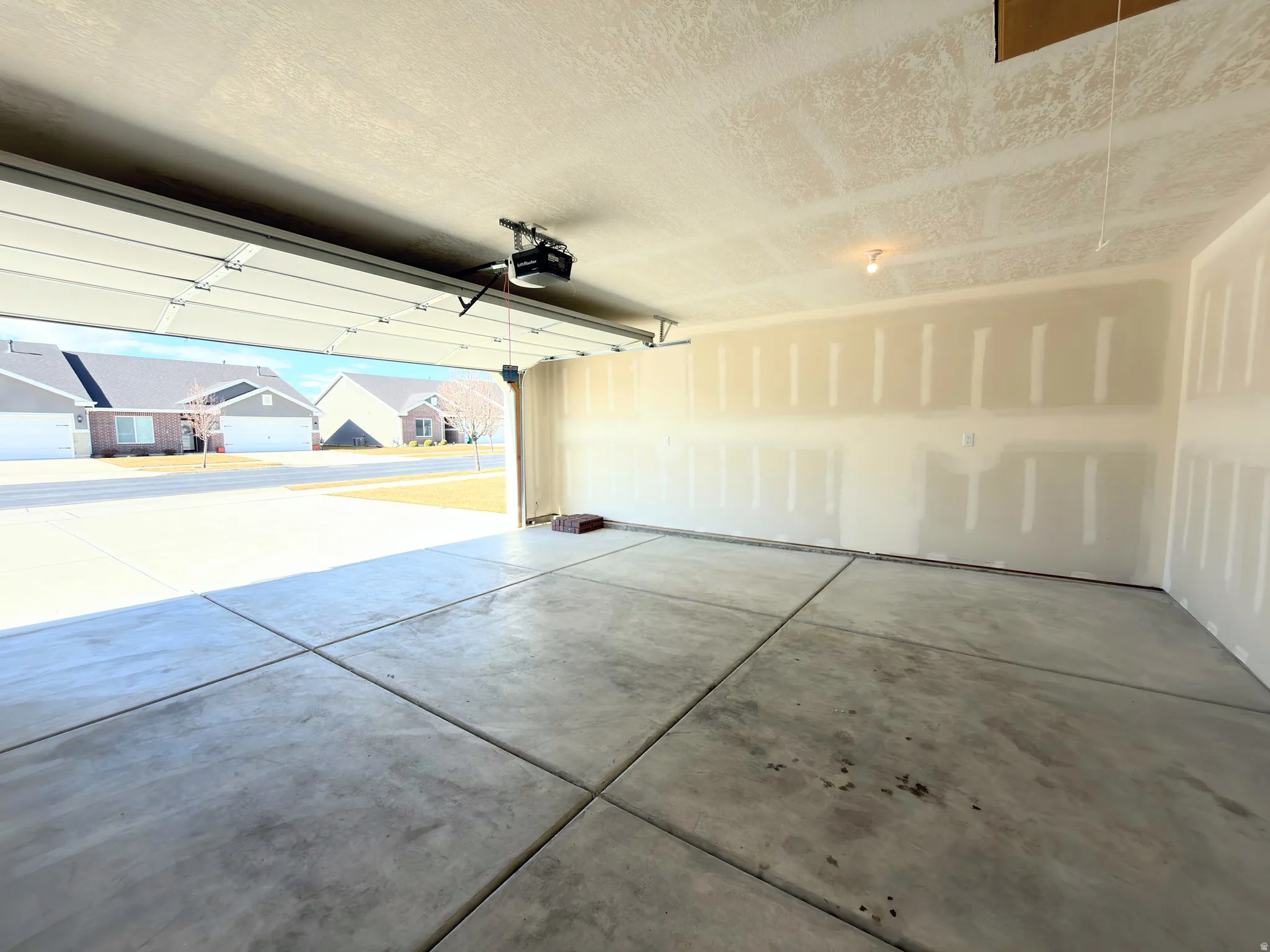 Garage with a residential view and a garage door opener