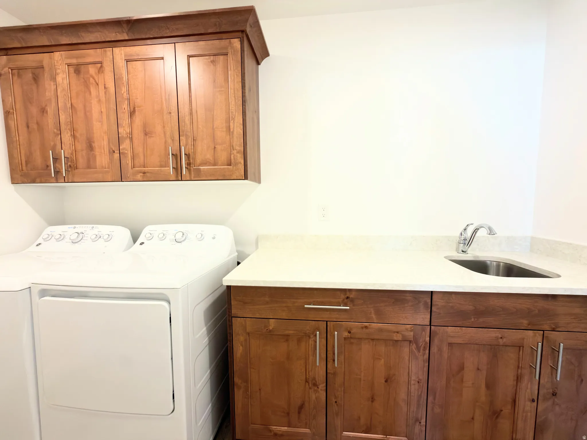 Laundry room featuring cabinet space and washer and clothes dryer