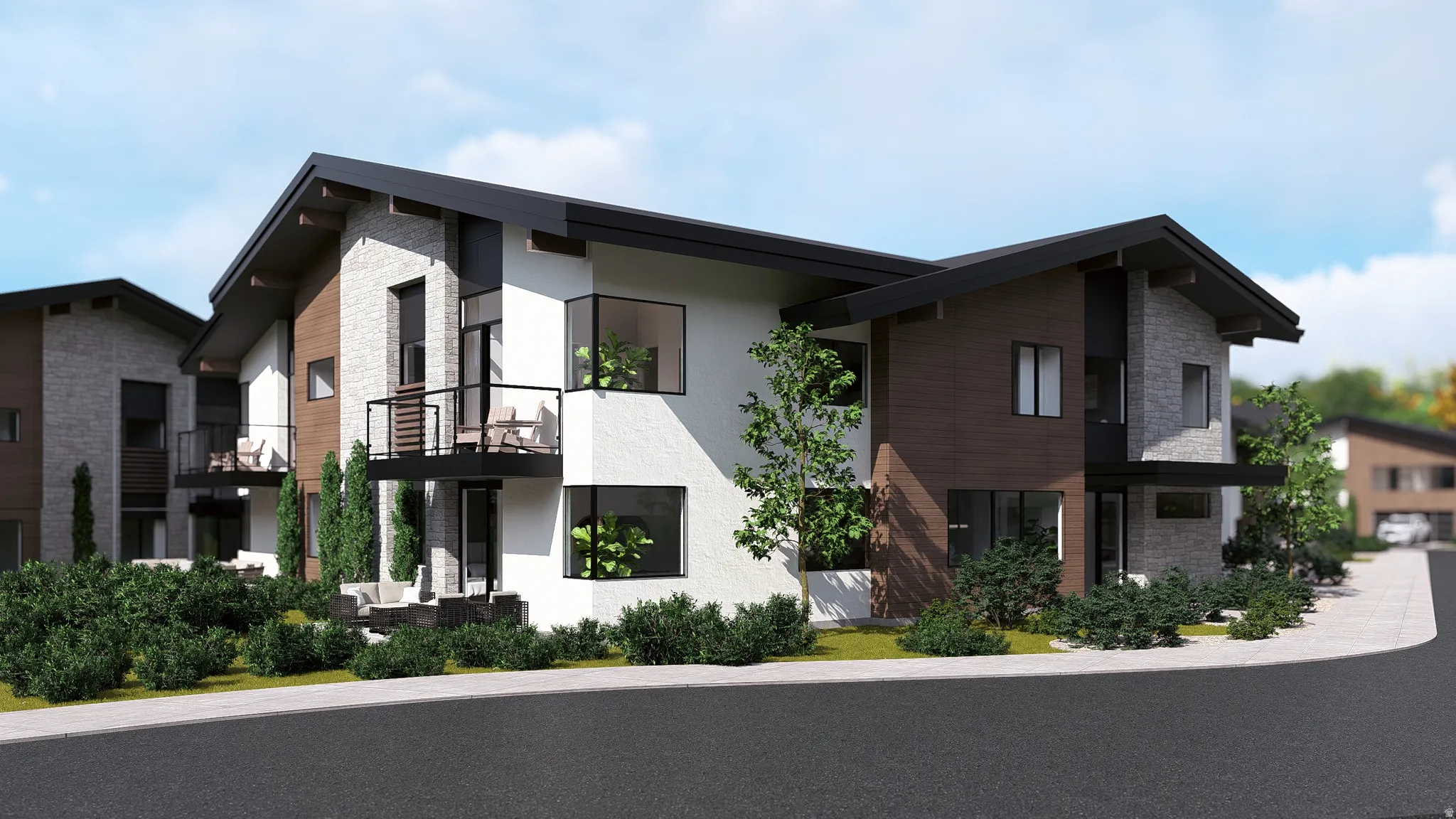 View of front facade featuring a balcony, stucco siding, and stone siding