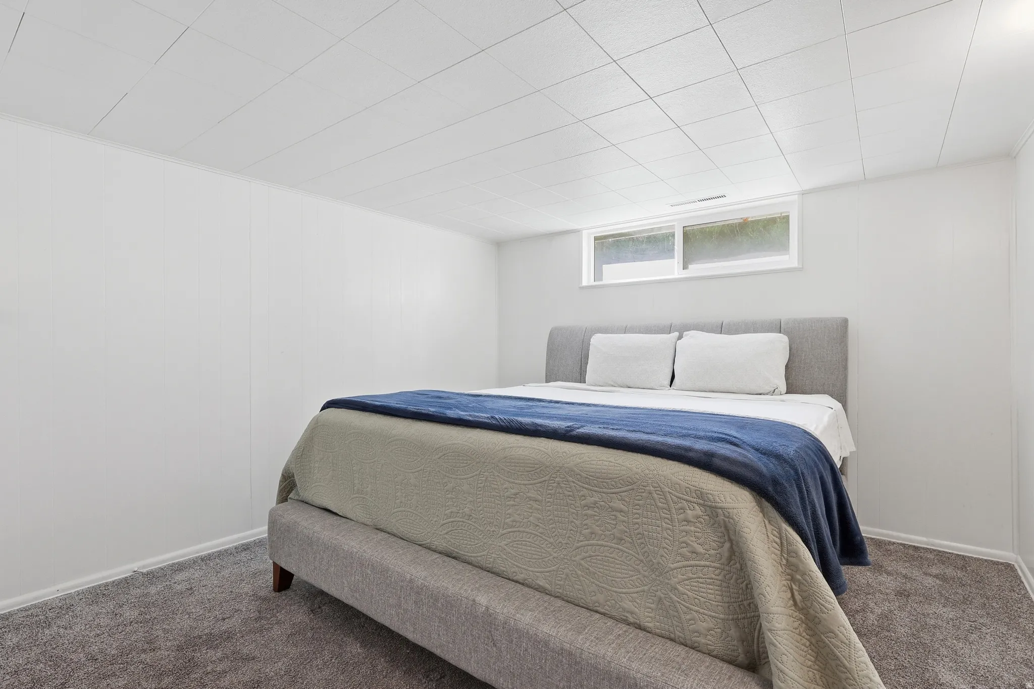 Carpeted bedroom with baseboards