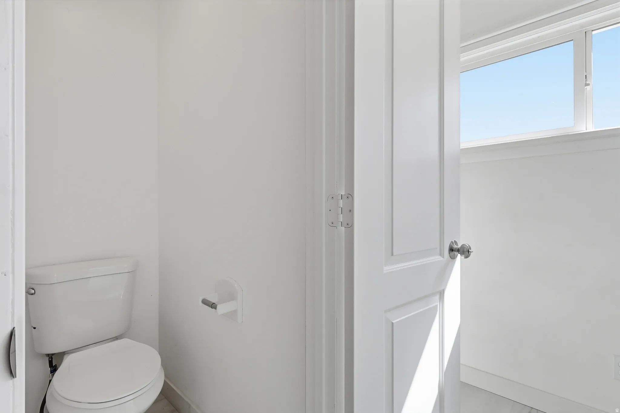 Bathroom featuring toilet and baseboards