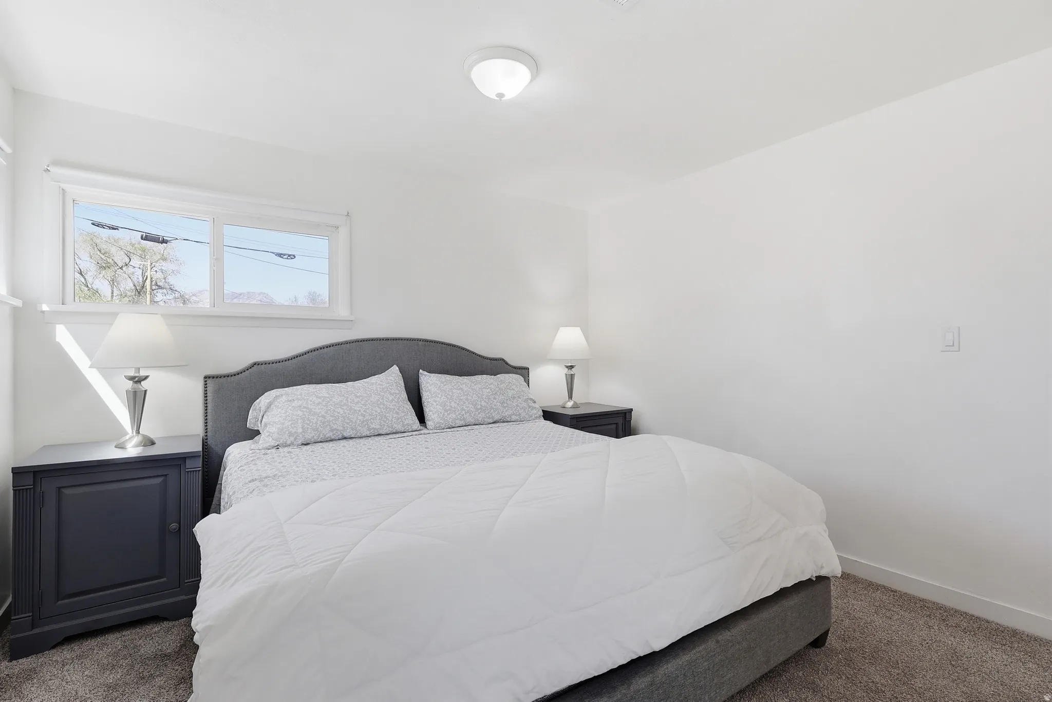 Bedroom featuring carpet and baseboards