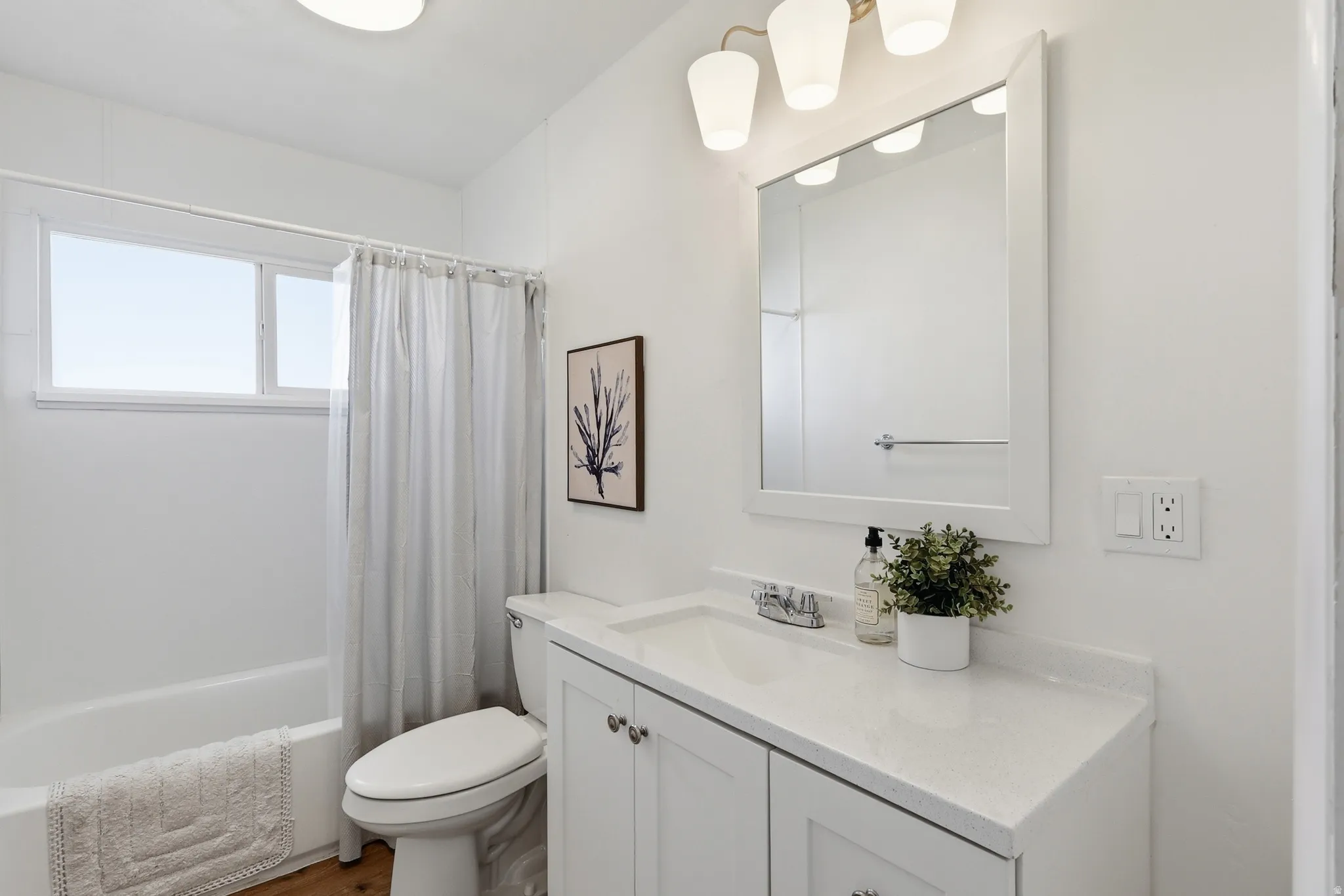 Bathroom with vanity and shower / bath combination with curtain
