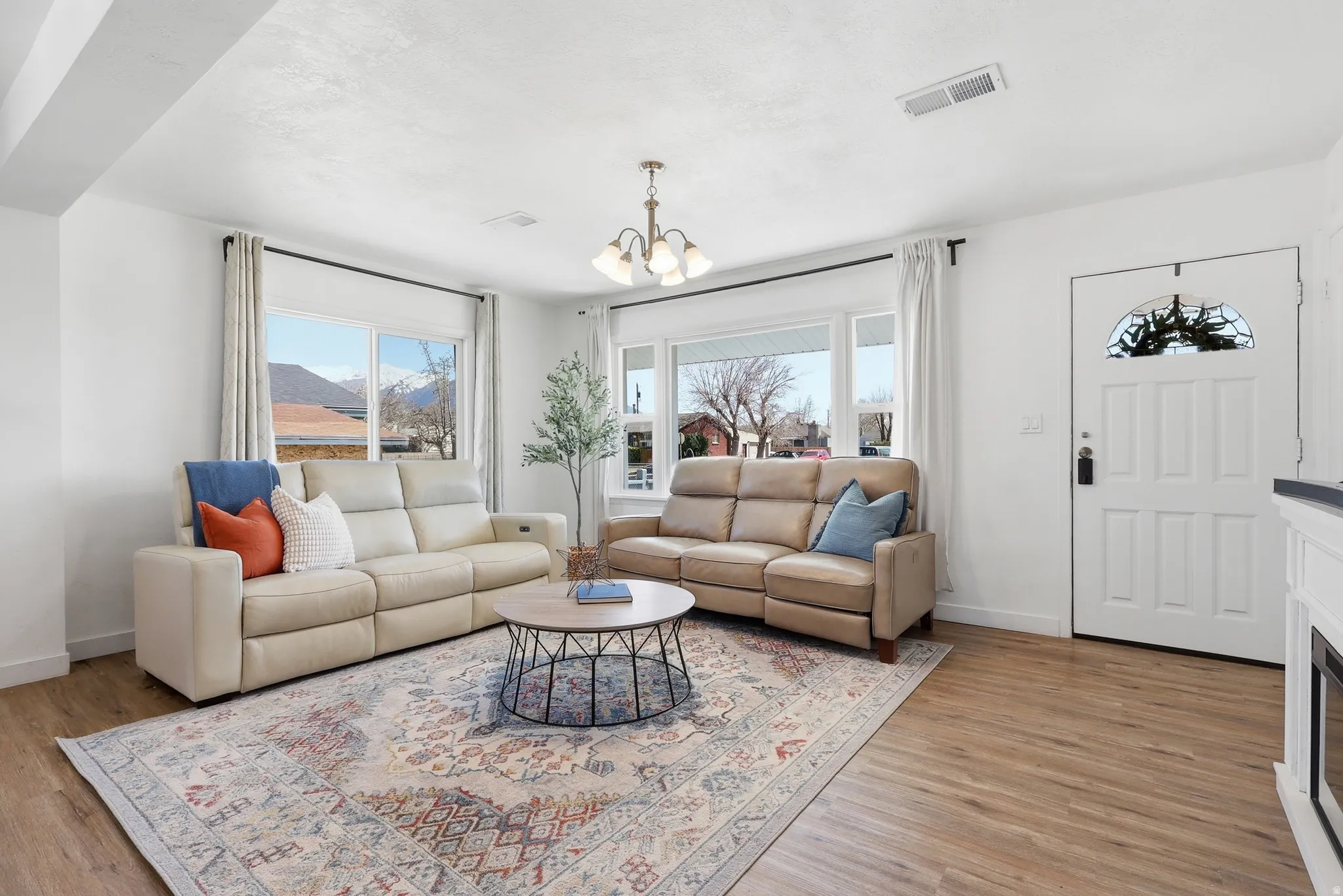 Living room with a chandelier and light wood-type flooring