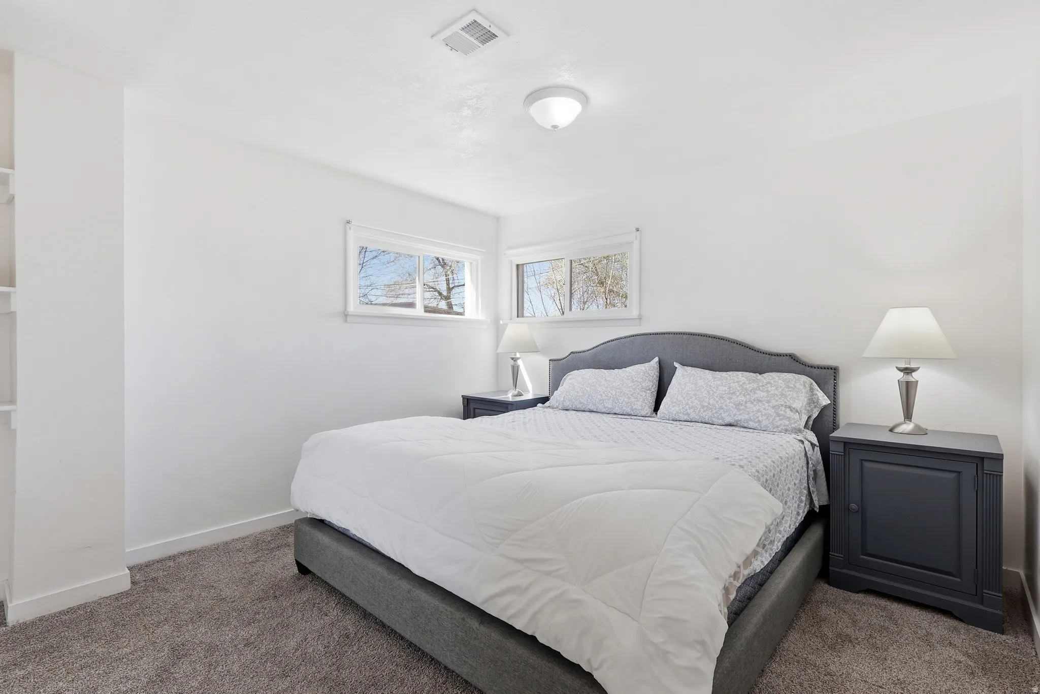 Carpeted bedroom with baseboards