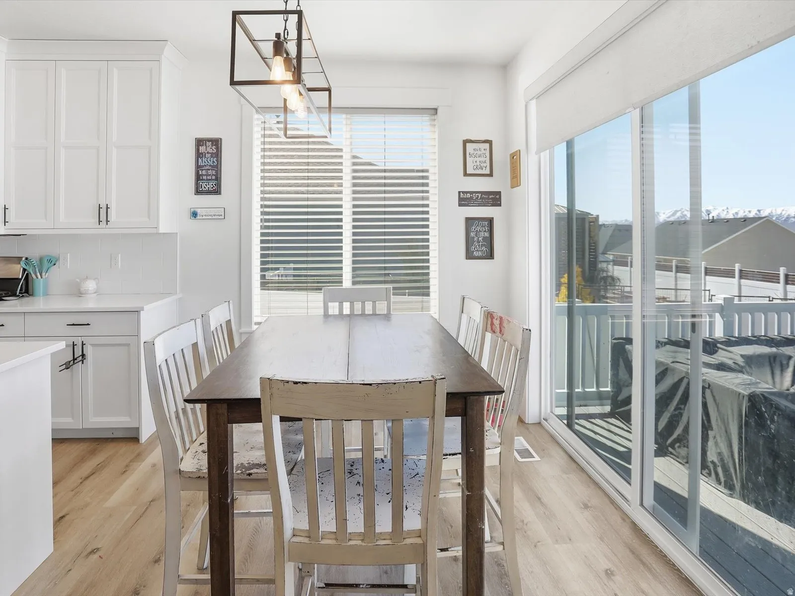 Dining area featuring light wood-type flooring and hanging lights