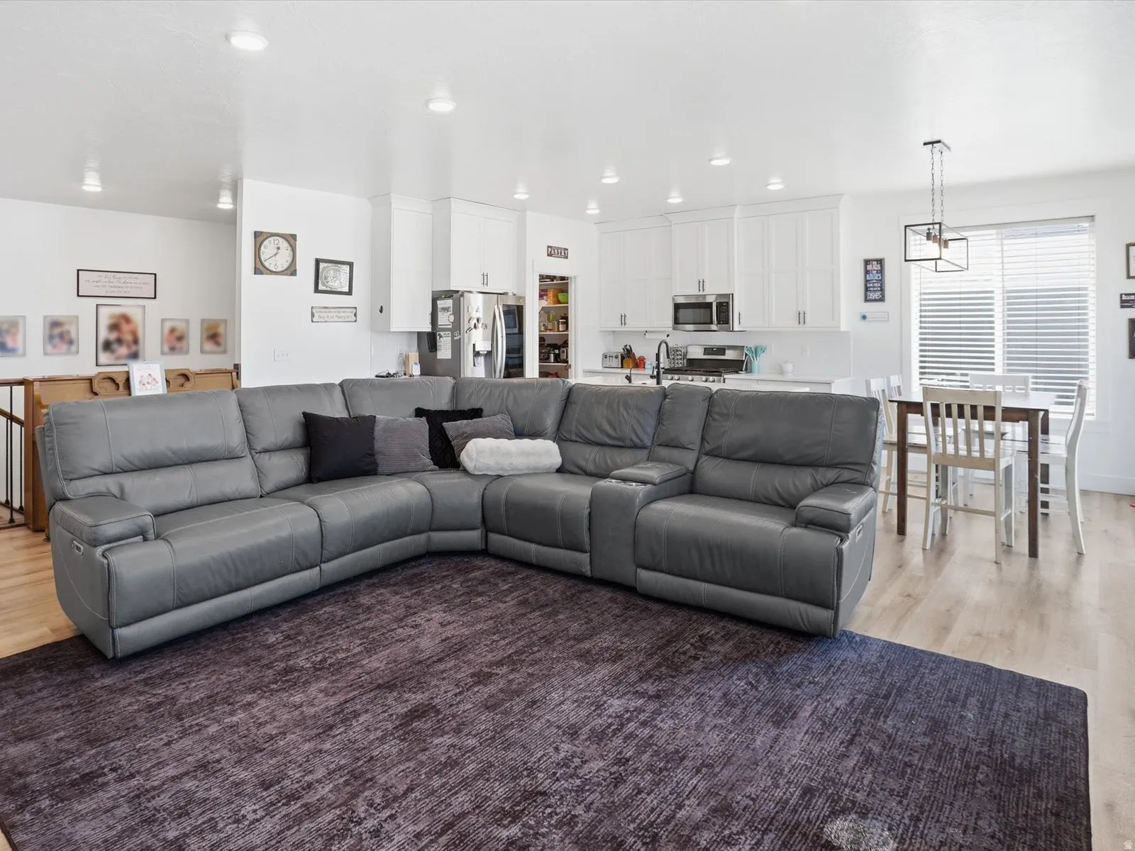 Living area with light wood-style floors and recessed lighting