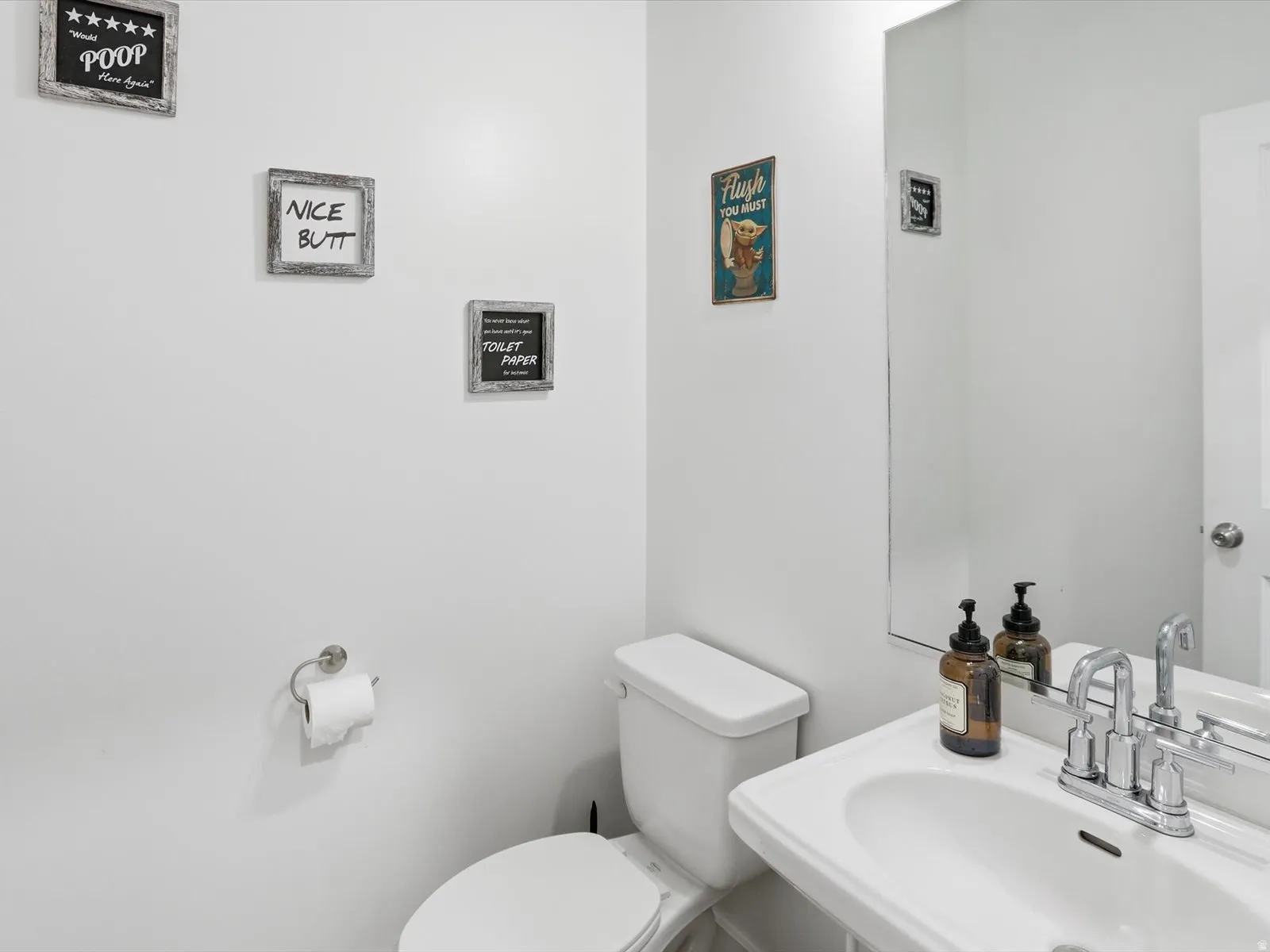 Half bath featuring toilet and a sink