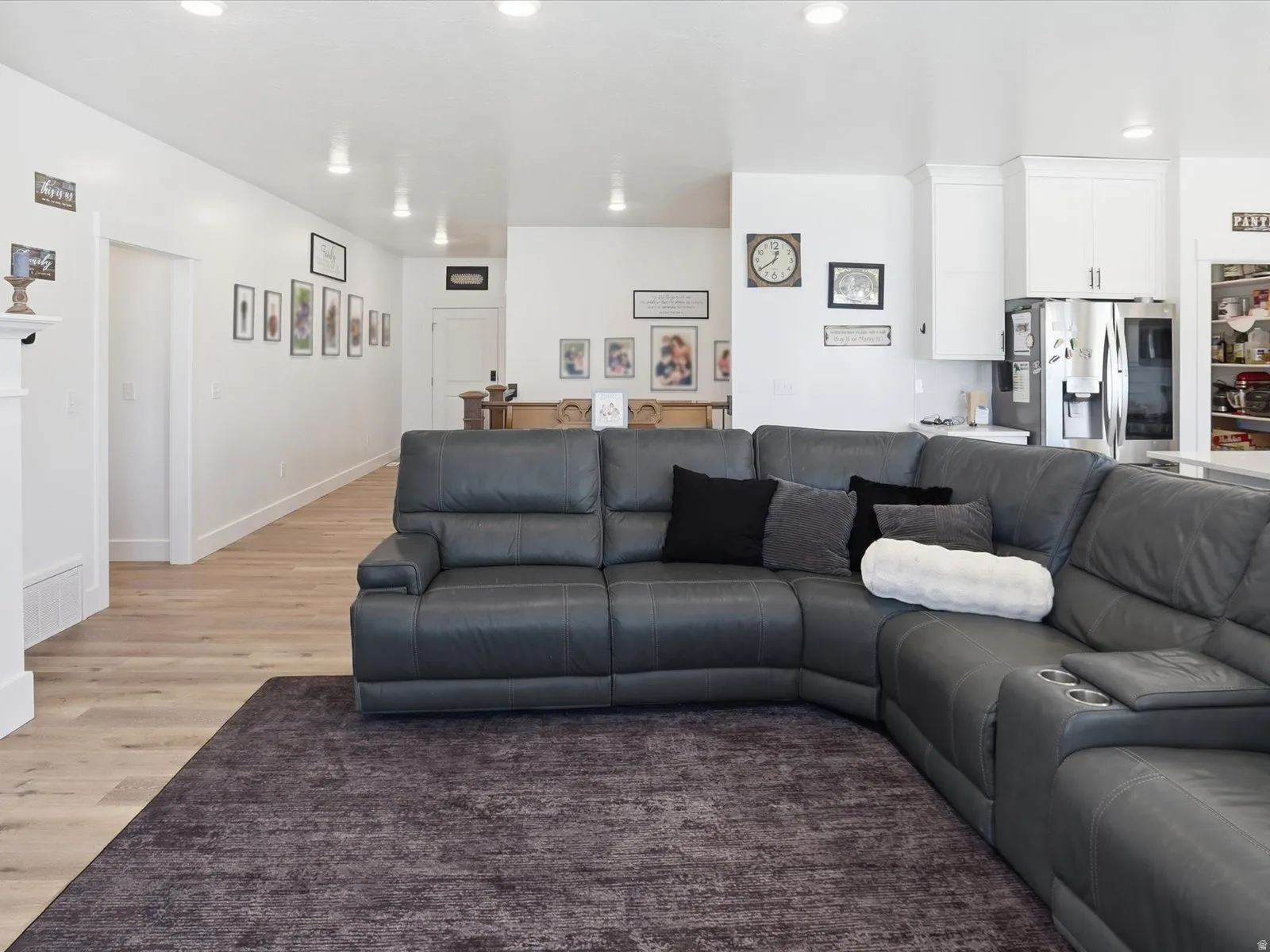Living room with light wood-style floors and recessed lighting