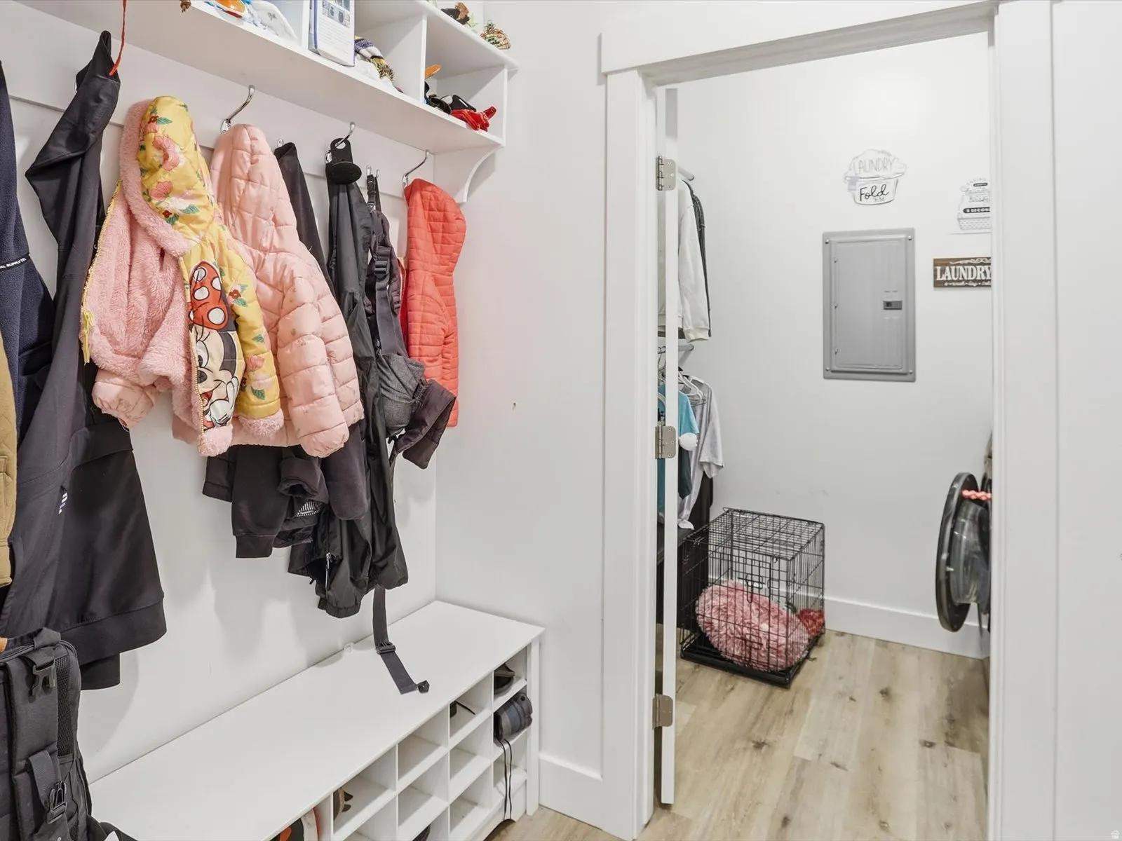 Mudroom featuring light wood-style floors and electric panel