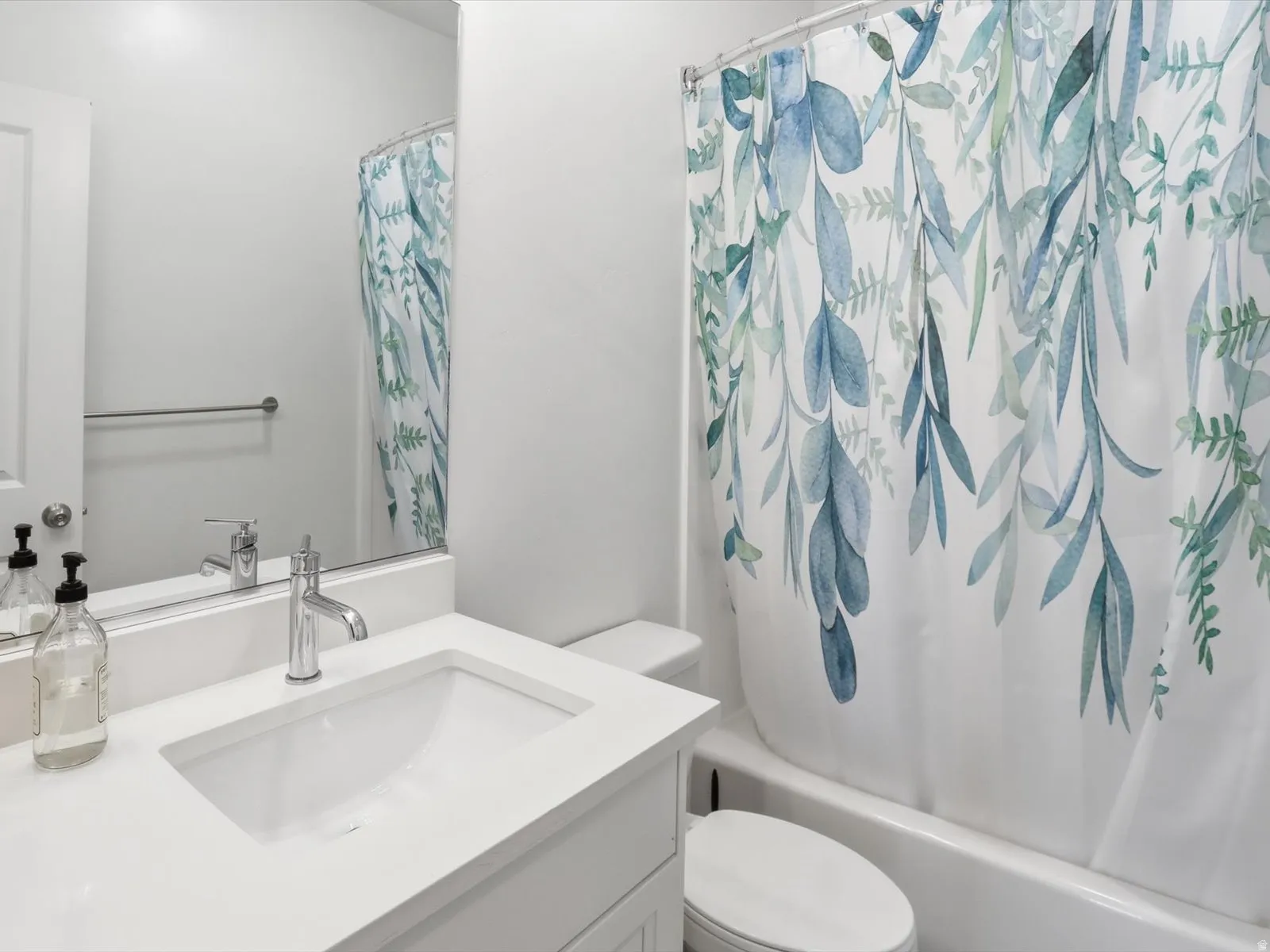 Full bathroom featuring vanity and shower / bath combo with shower curtain