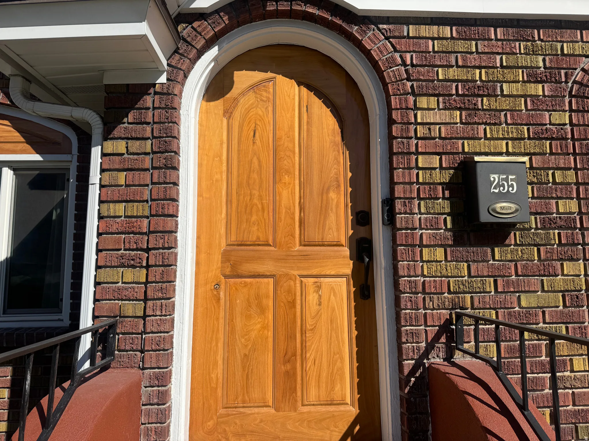 Doorway to property with brick siding