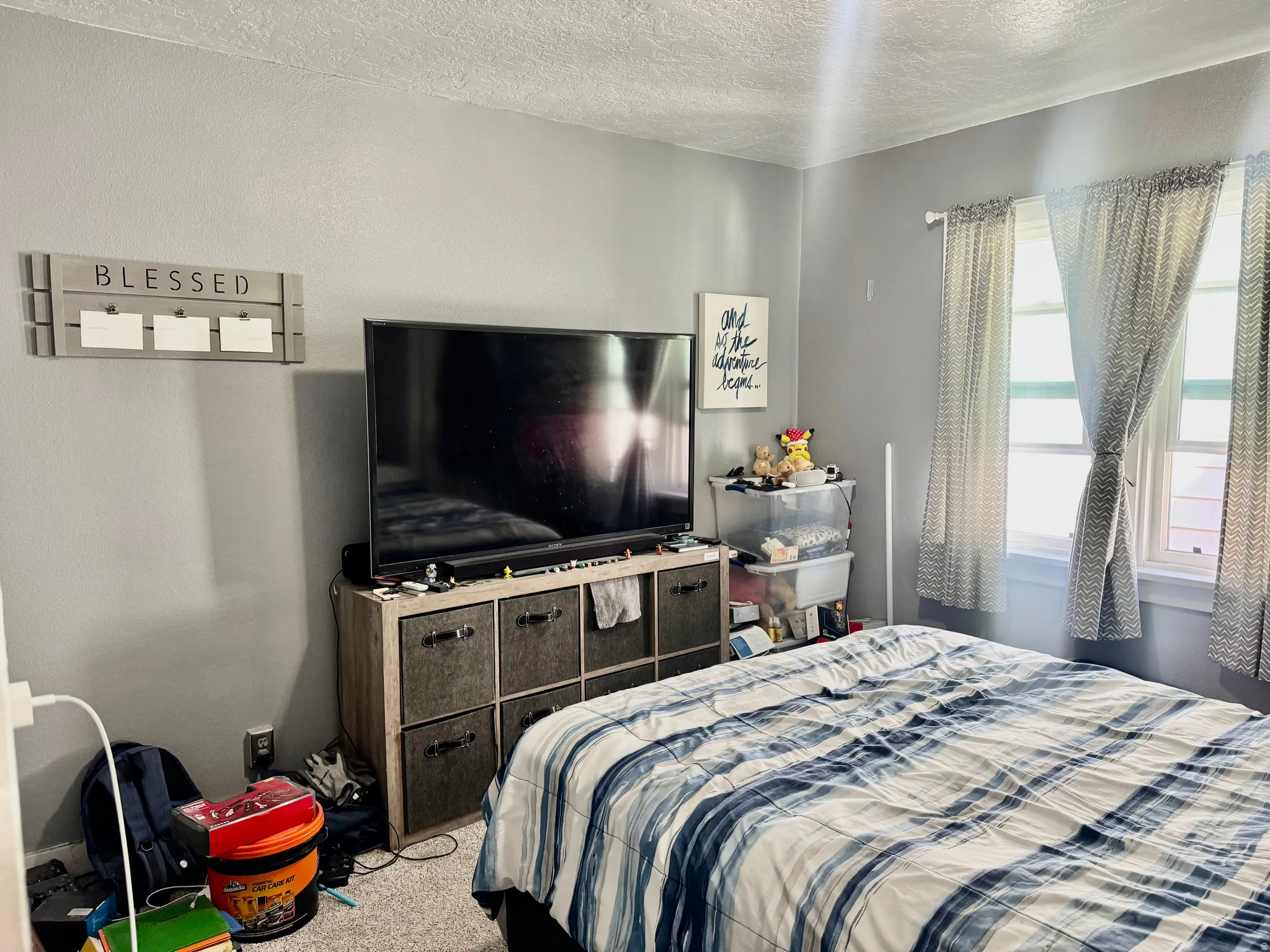 Bedroom featuring a textured ceiling and carpet flooring