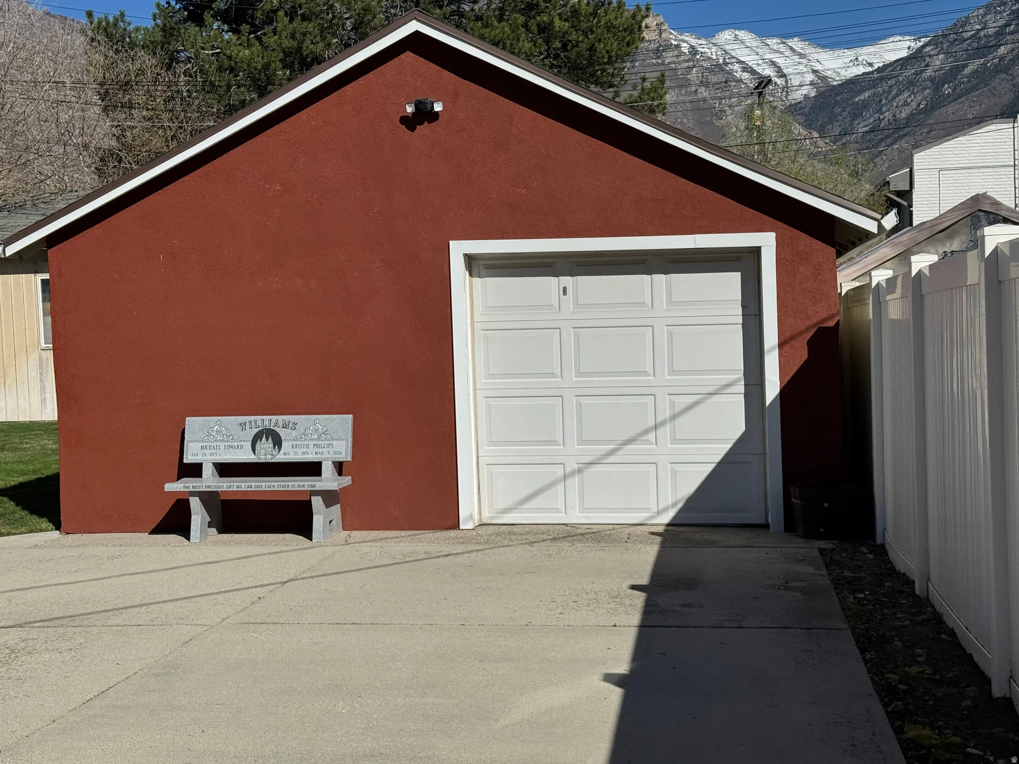 Detached garage featuring driveway and a mountain view