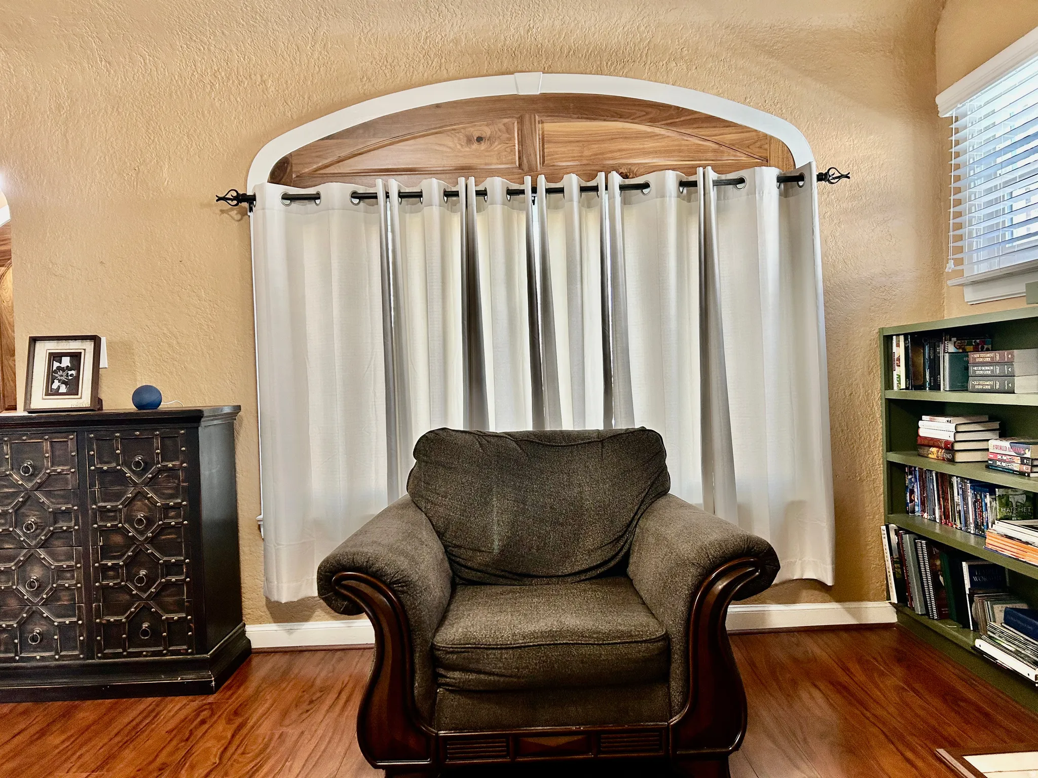 Living area with a textured wall and wood finished floors