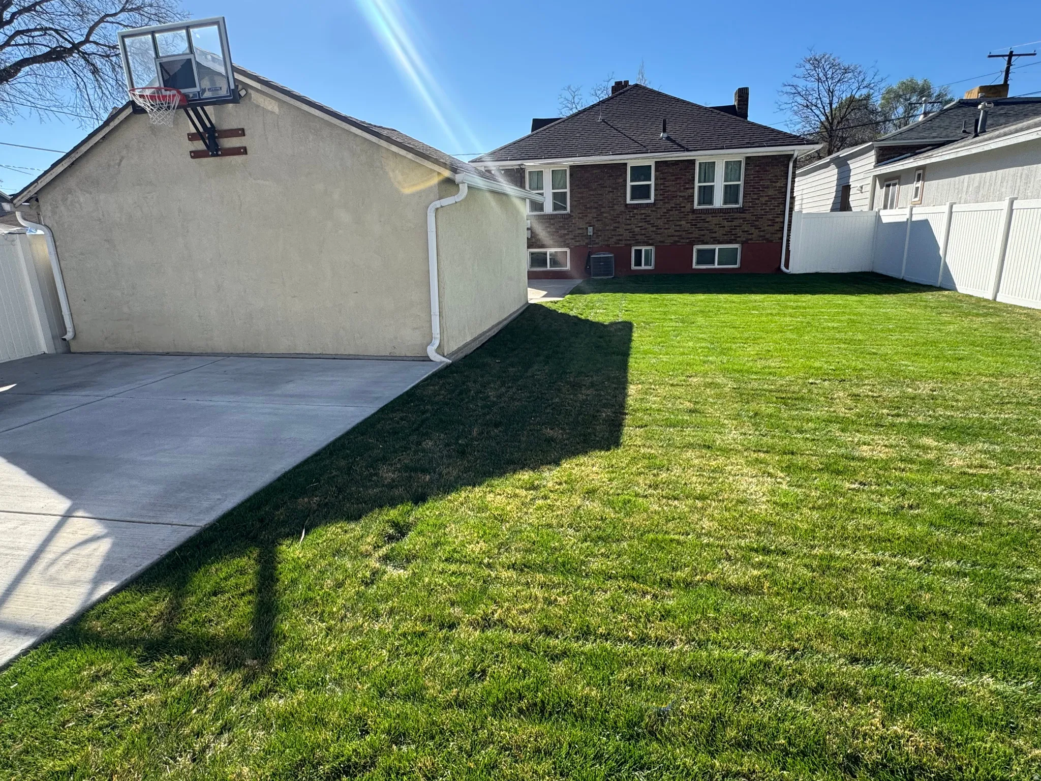 Rear view of property with stucco siding and brick siding