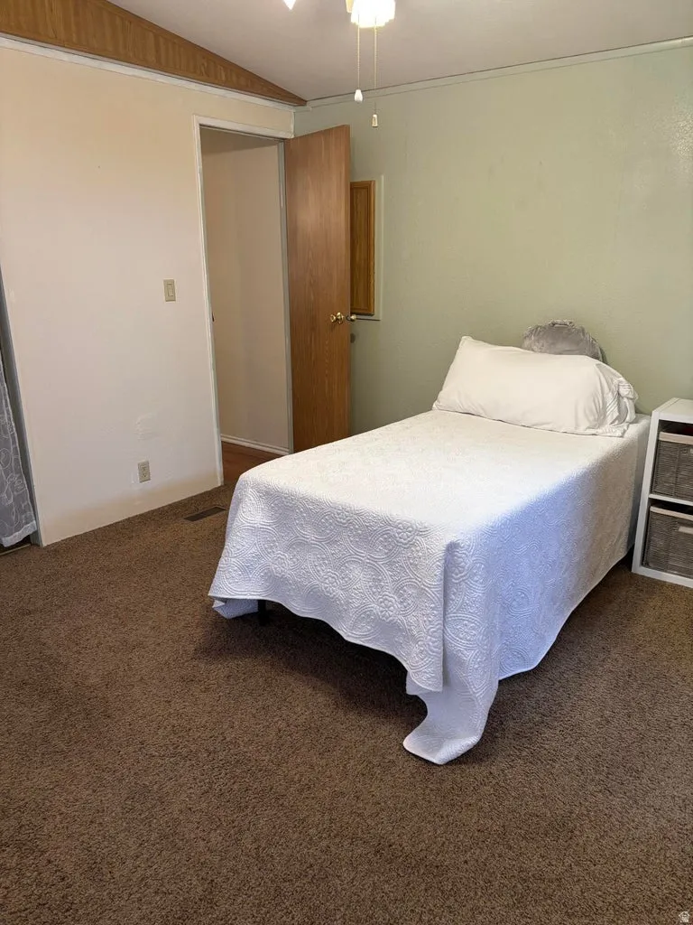 Bedroom featuring carpet and lofted ceiling