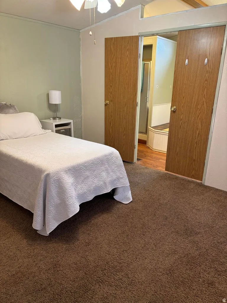 Bedroom featuring carpet, a ceiling fan, and crown molding
