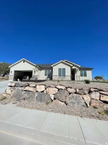 Ranch-style house with a garage and concrete driveway