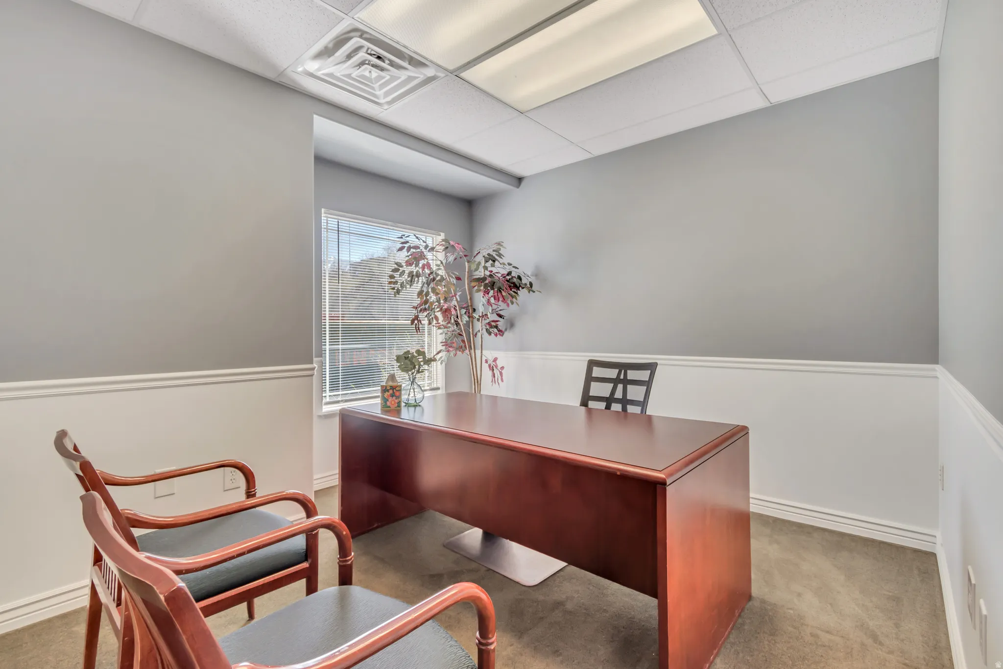 Office area featuring a paneled ceiling