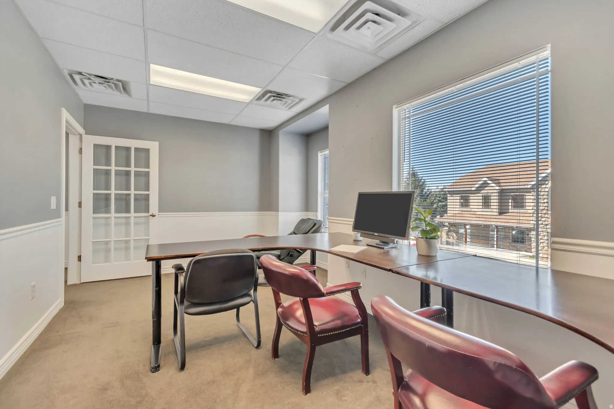 Office with a paneled ceiling
