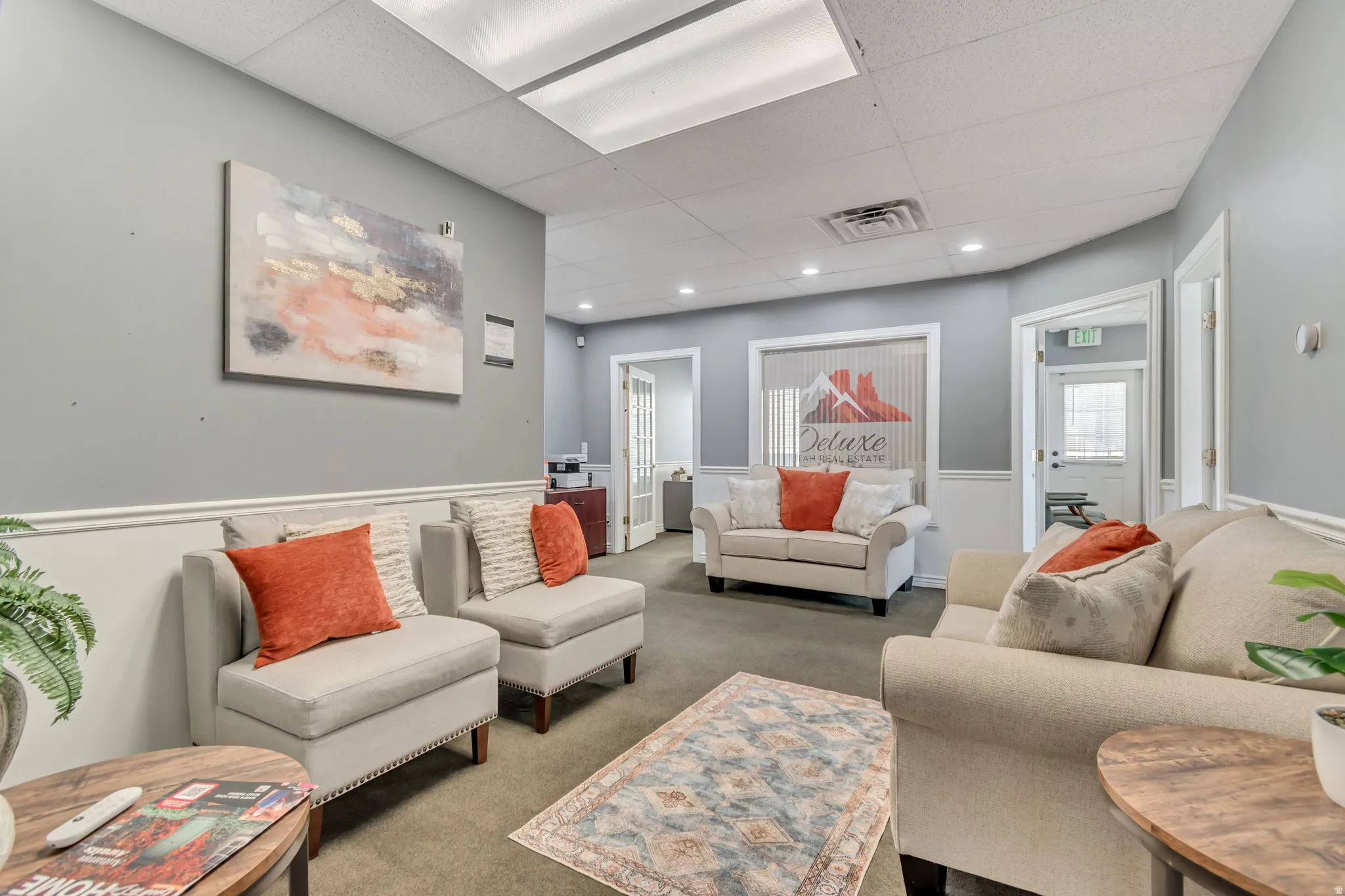 Living room featuring a paneled ceiling and carpet