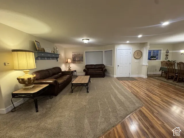 Living room with baseboards and dark wood-style floors