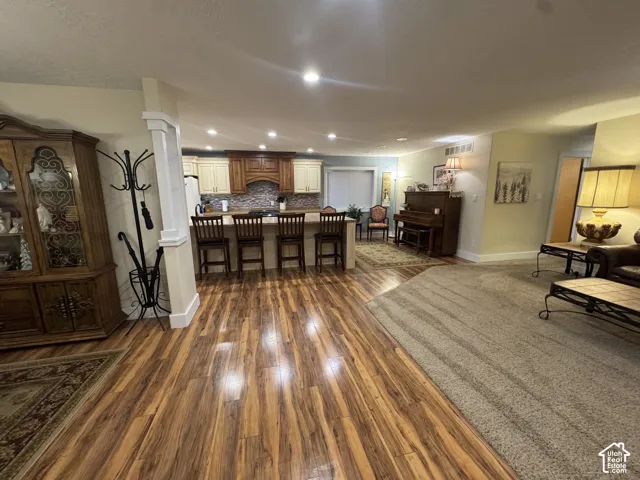 Living room with dark wood finished floors and recessed lighting