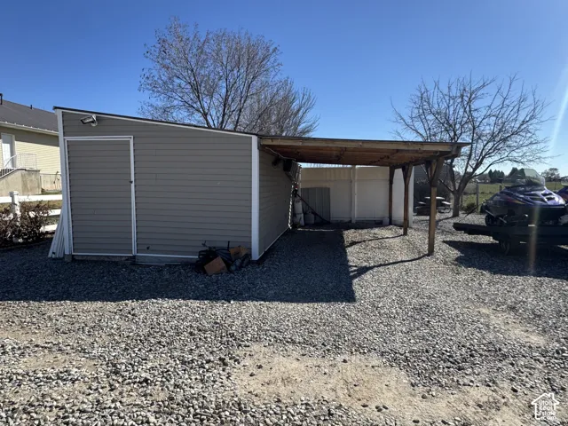 View of outdoor structure featuring an attached carport
