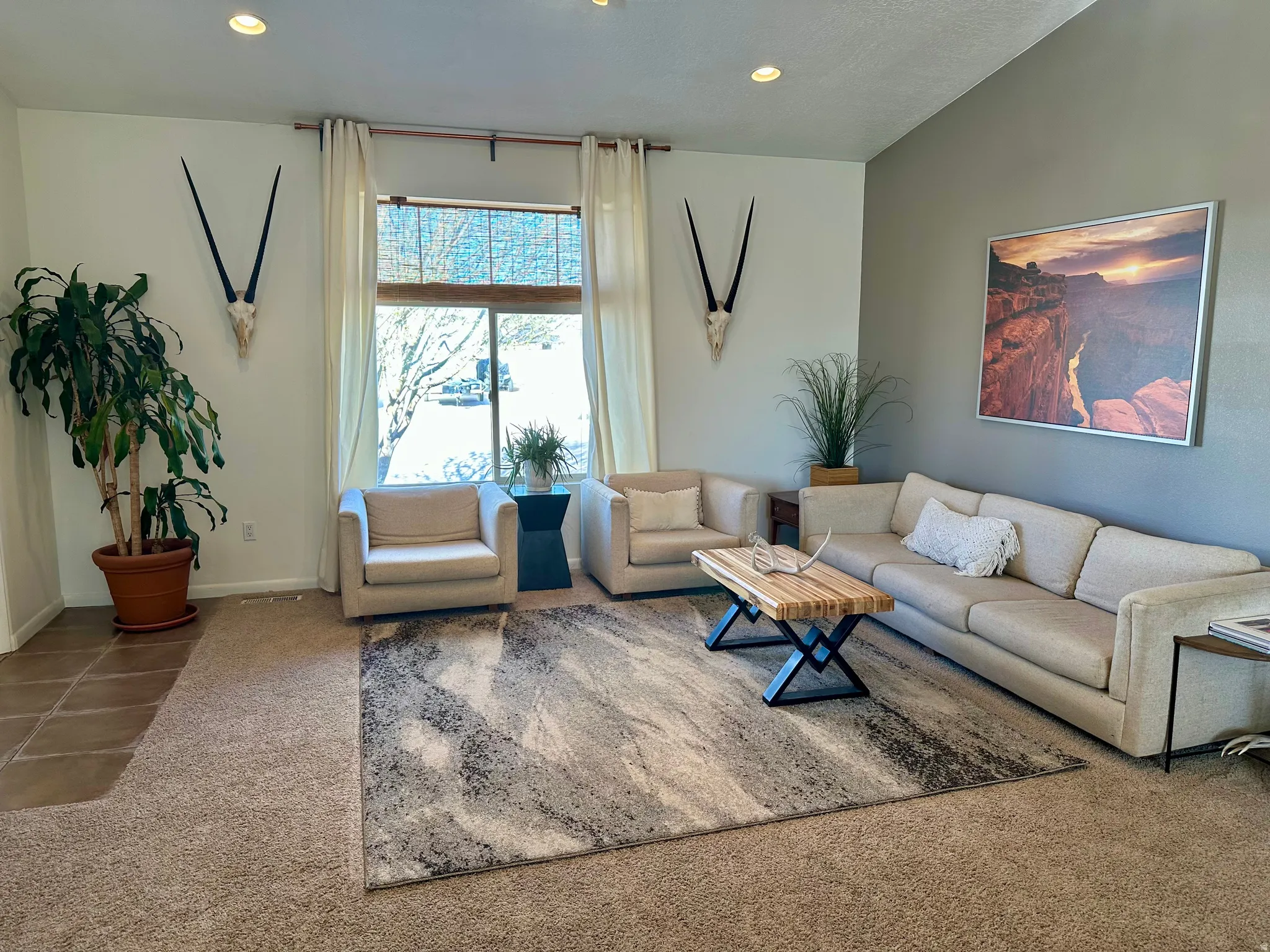 Carpeted living room featuring recessed lighting and baseboards
