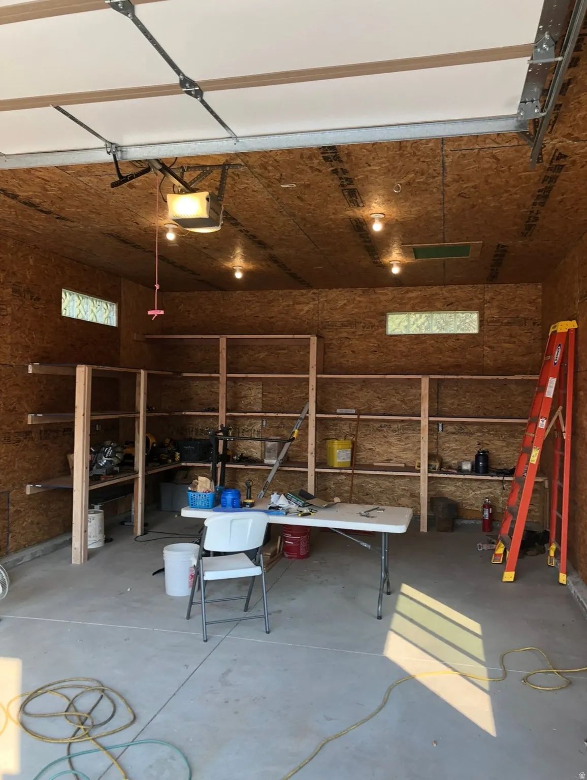 Garage with a workshop area and a garage door opener