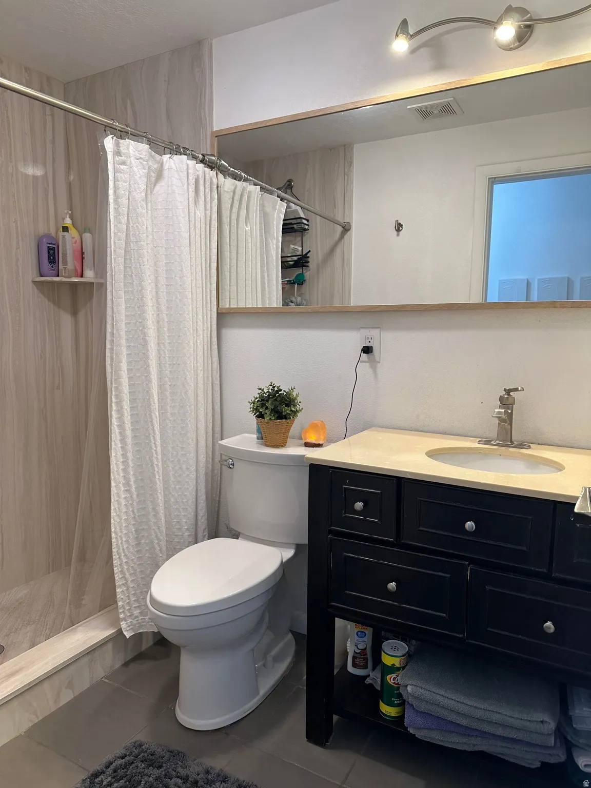 Full bathroom with vanity, tile patterned flooring, and a stall shower