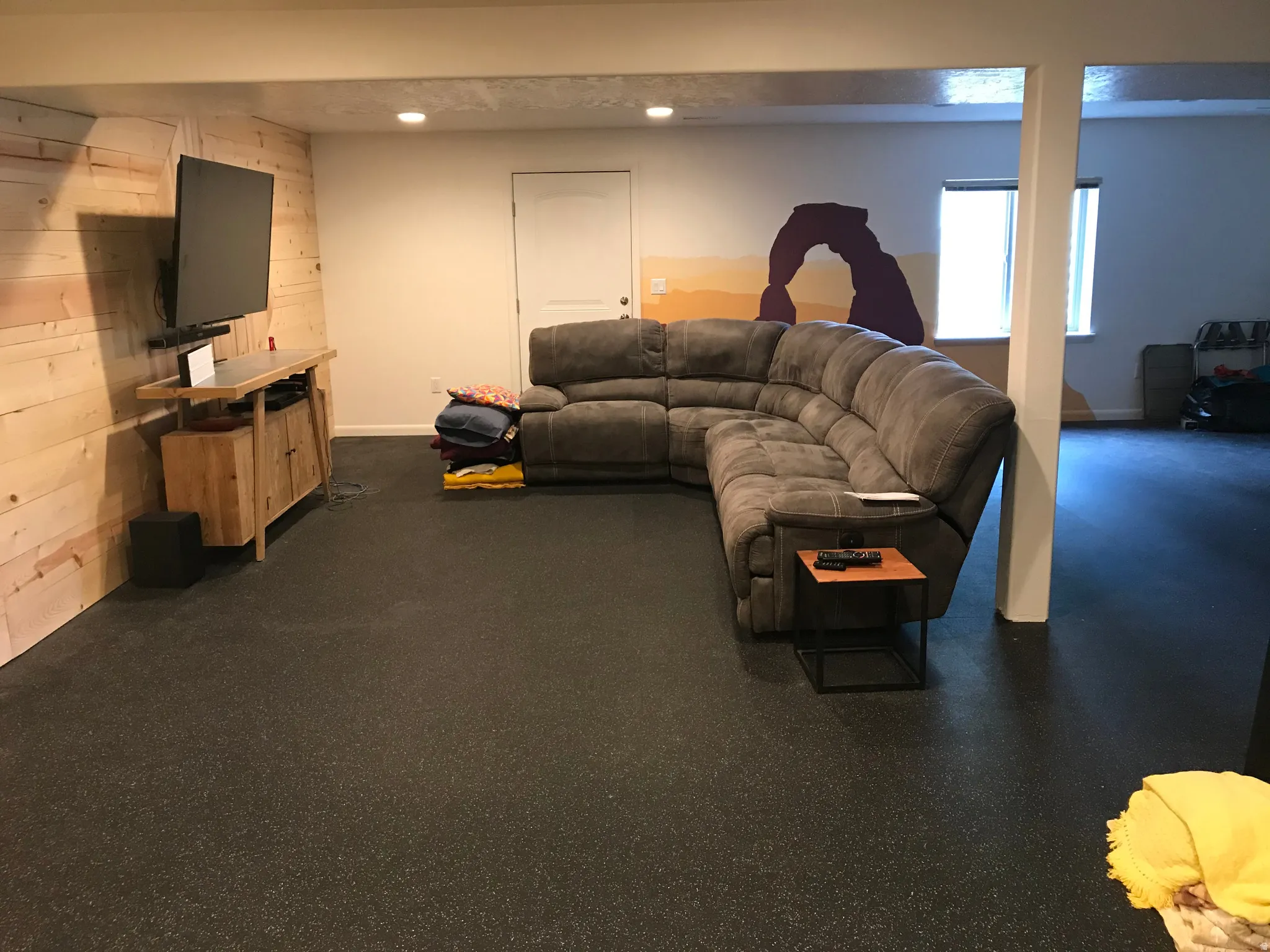 Living area featuring baseboards and wood walls