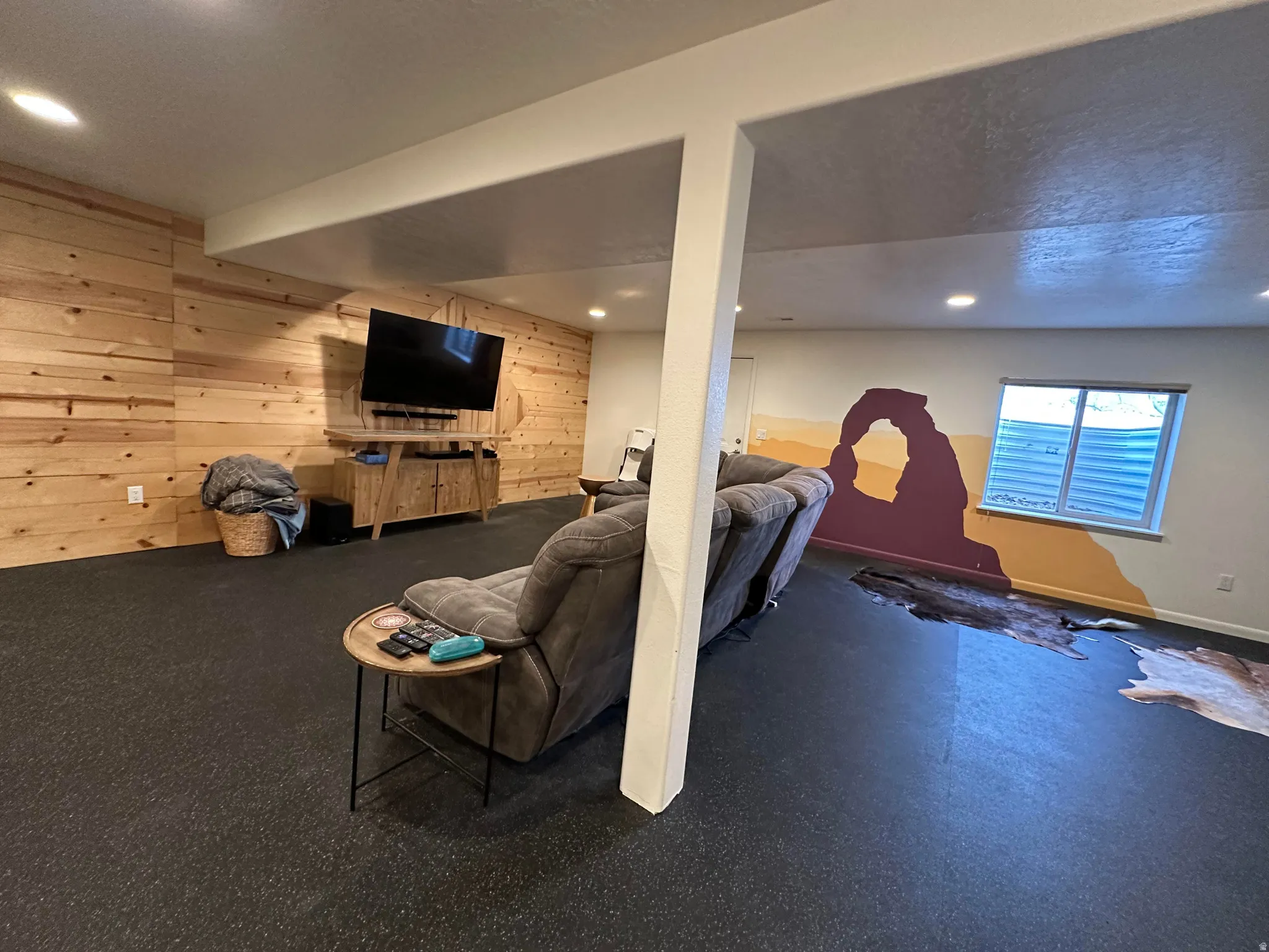 Living room featuring wood walls and recessed lighting