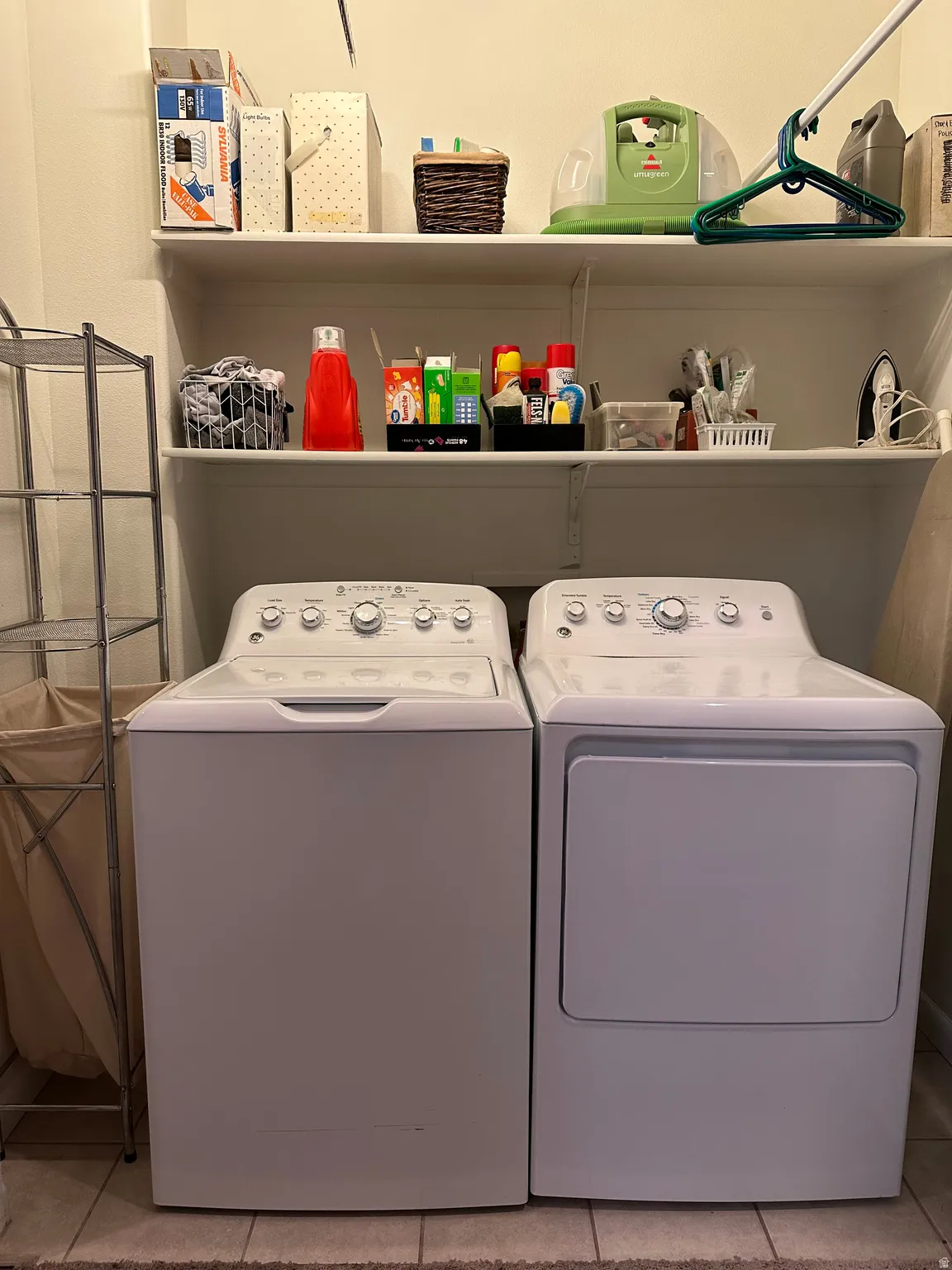 Laundry room featuring washer and dryer and light tile patterned flooring