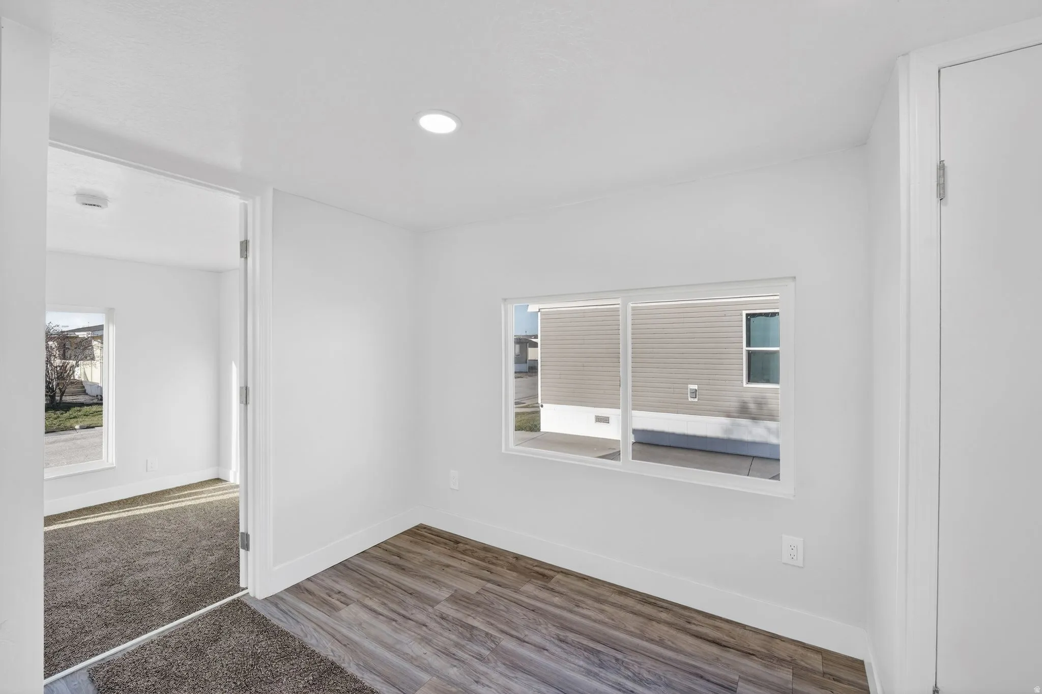Spare room featuring wood finished floors and healthy amount of natural light