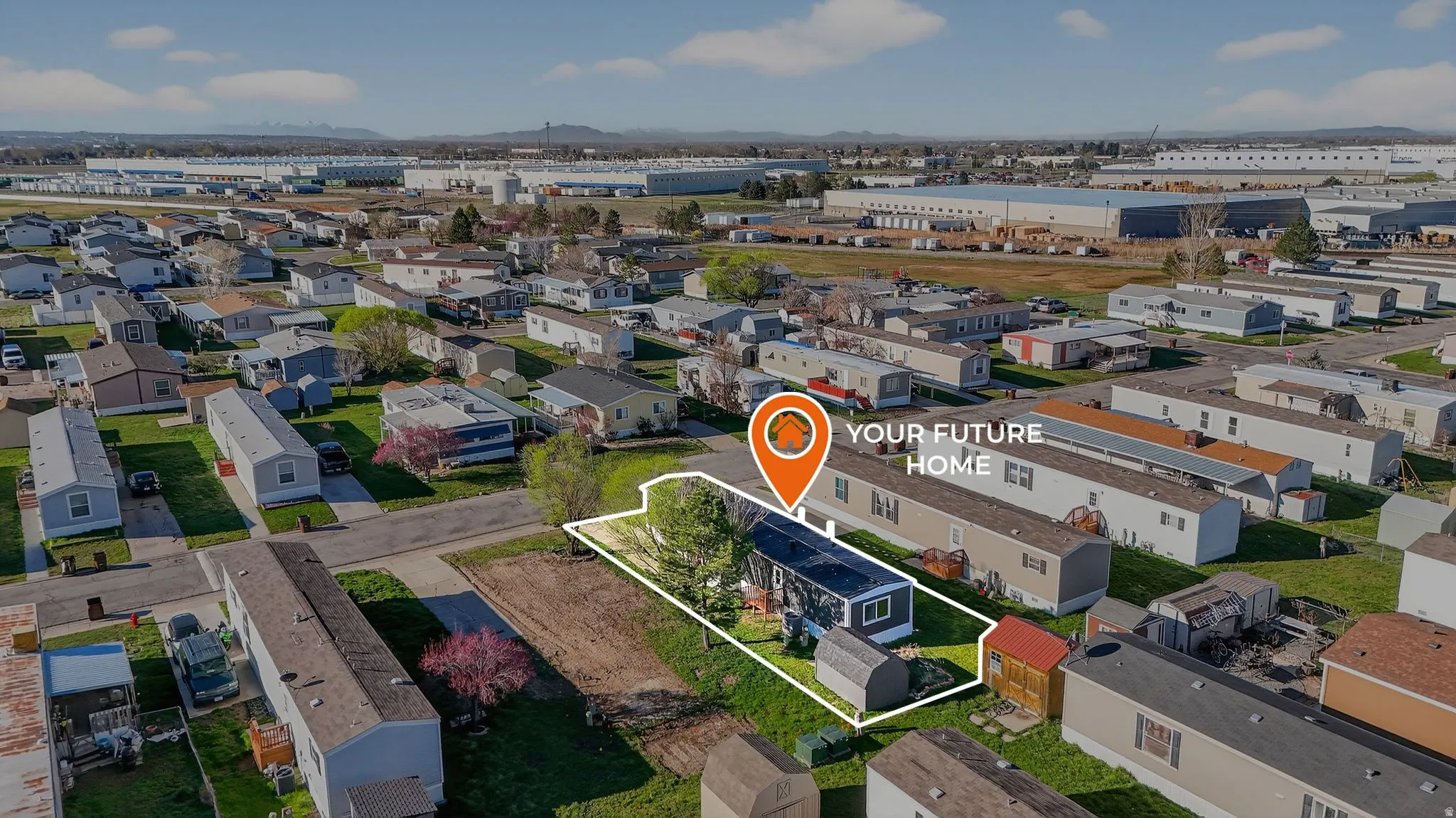 Aerial view of property and surrounding area featuring property parcel outlined and an industrial area