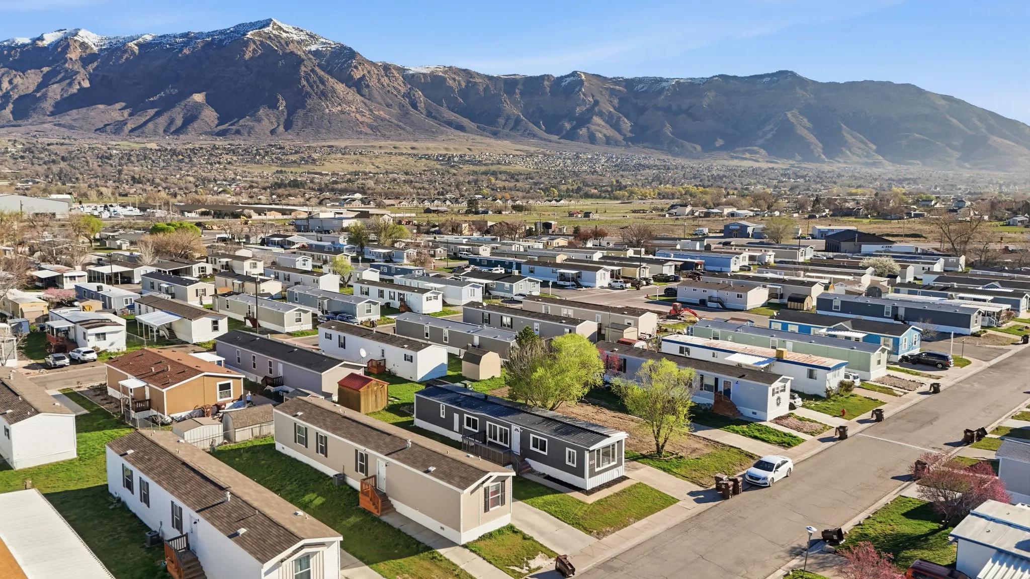 Aerial overview of property's location featuring nearby suburban area and a mountain backdrop