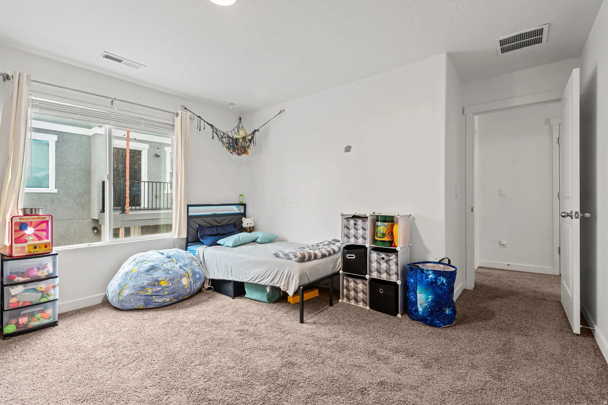 Carpeted bedroom featuring baseboards