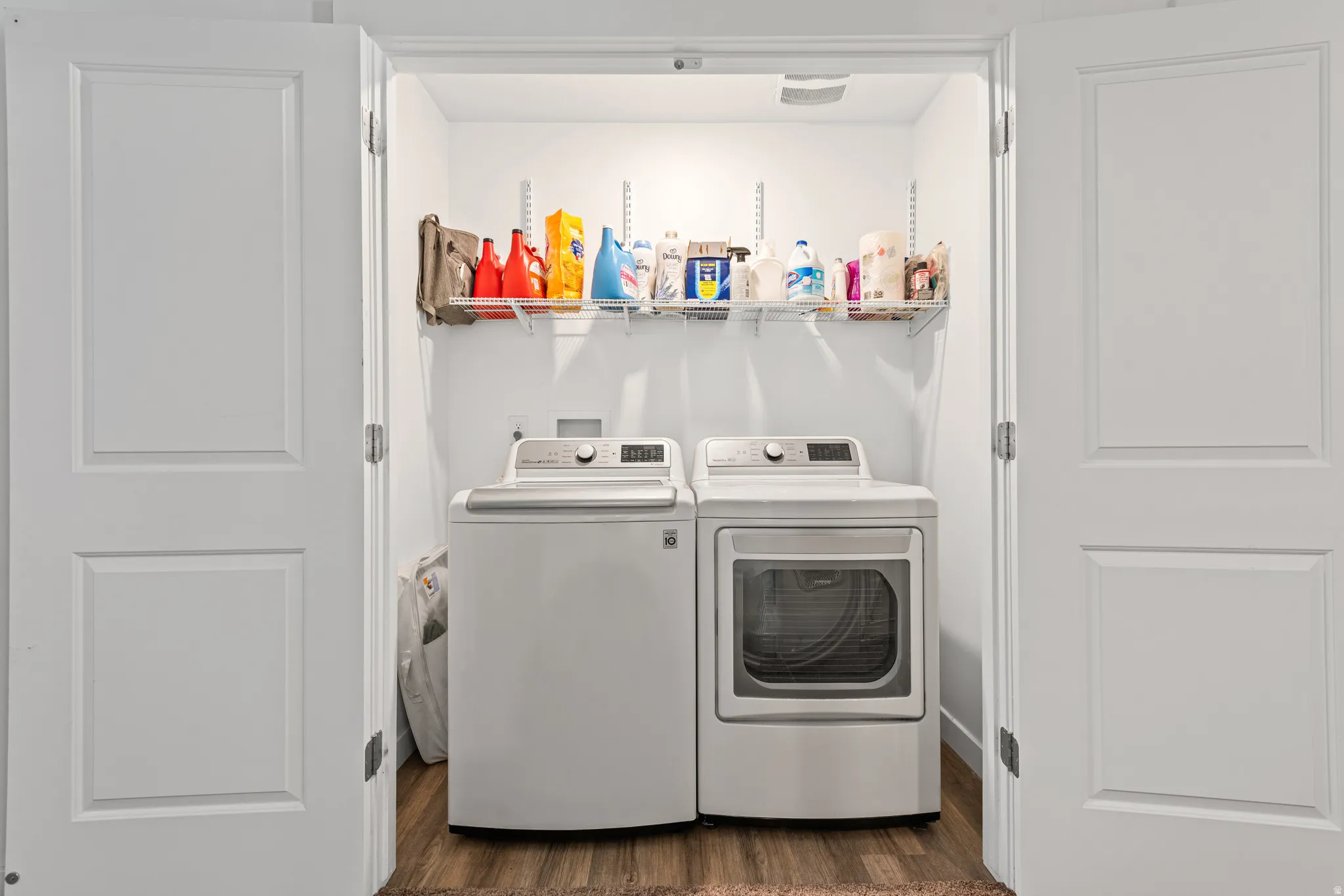 Laundry area featuring dark wood-style floors and separate washer and dryer