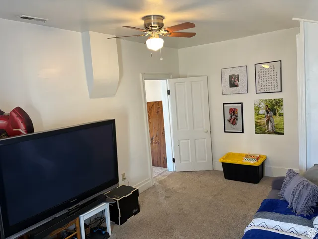 Bedroom featuring carpet and ceiling fan