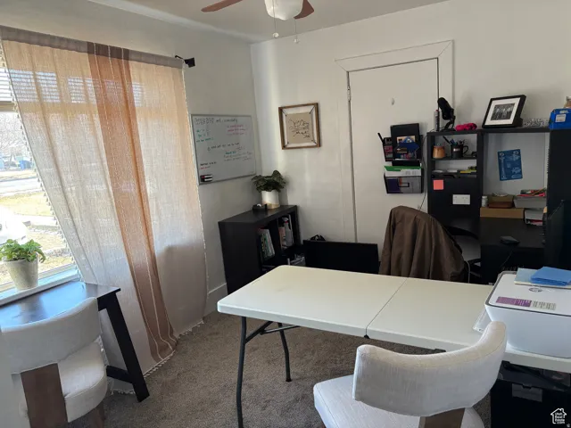 Office area featuring carpet flooring and a ceiling fan