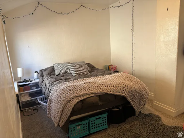 Carpeted bedroom featuring baseboards